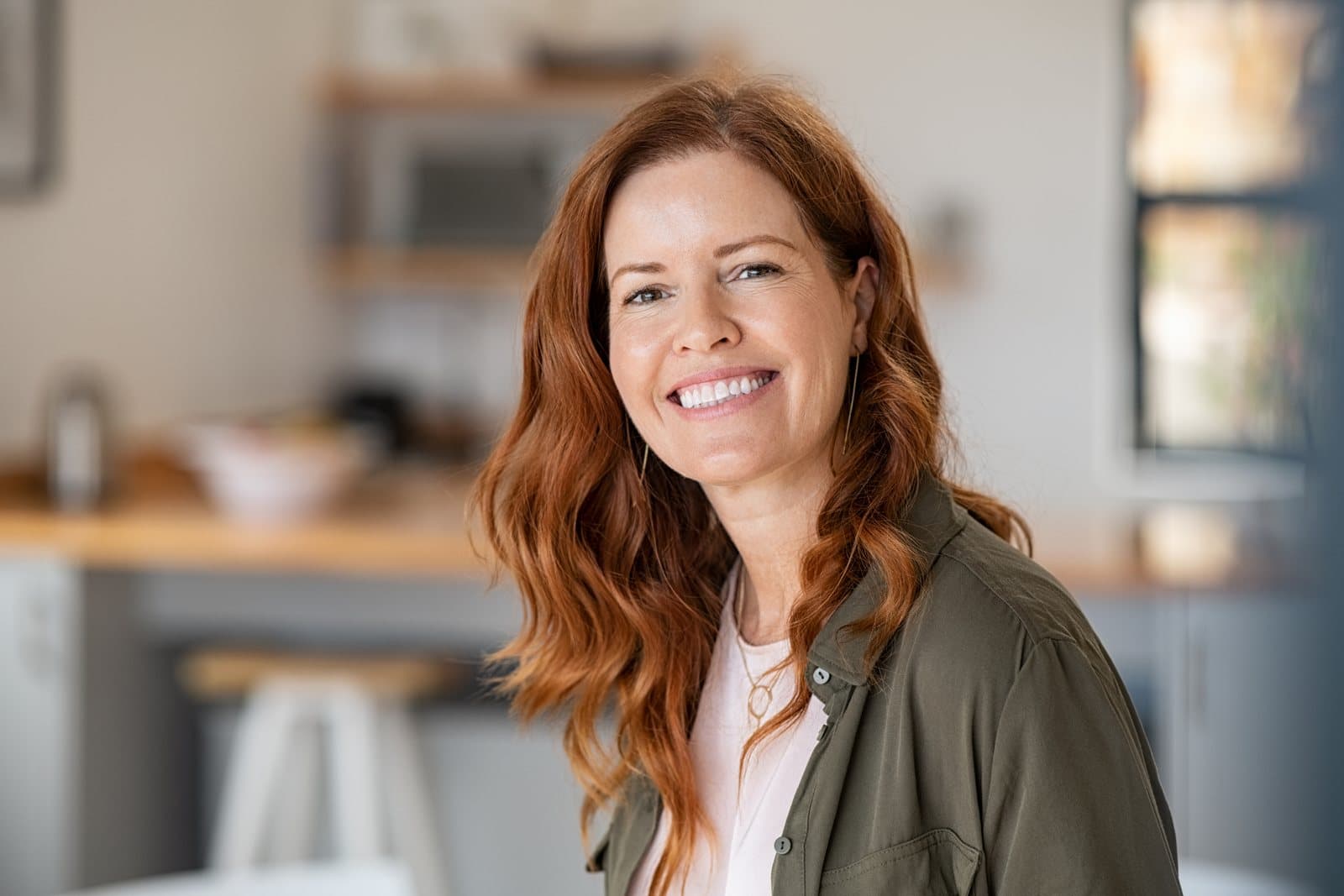 Smiling woman with bright white teeth after professional whitening at Brampton Smiles in Brampton